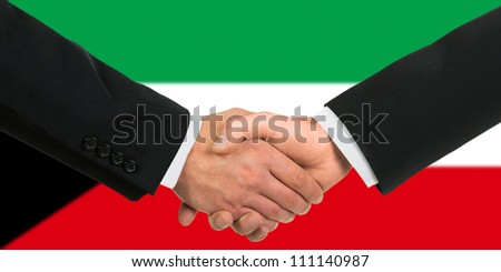 The Kuwaiti flag and business handshake