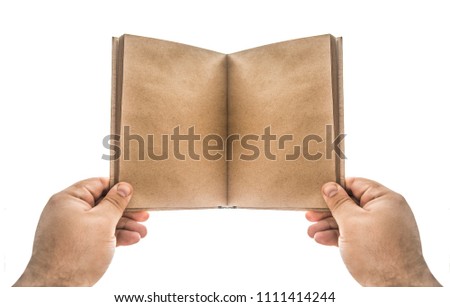 one hand holding blank white note book isolated on white background. File contains a clipping path.  empty open book with craft paper pages hold male hand.