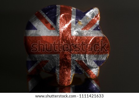 Piggy bank with British flag on a black background