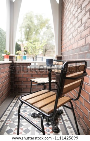 A dining setting on the patio of an old federation house with tuckpointing brickwork and tiling