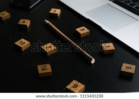 Some office staff - notebook, pencil, stickers and wooden letters - on black background office table