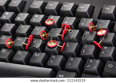Painful typing, pins on keyboard close-up