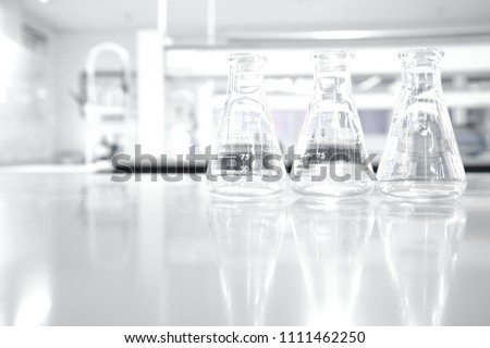 three glass flask in white clean research chemistry science laboratory background  Royalty-Free Stock Photo #1111462250