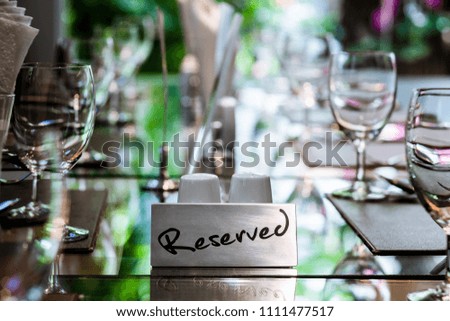 Reserved Metal Plate on the Table with Blurry background. Reservation Seat at restaurant.