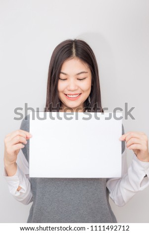 Beautiful young asian women holding blank white paper banner on white background