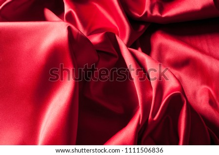 Background, texture, pattern Red Silk cloth of abstract backgrounds or wavy folds or satiny silk texture satin velvet material or elegant wallpaper design curve.