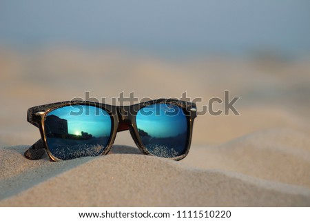 Sunglasses in beach sand