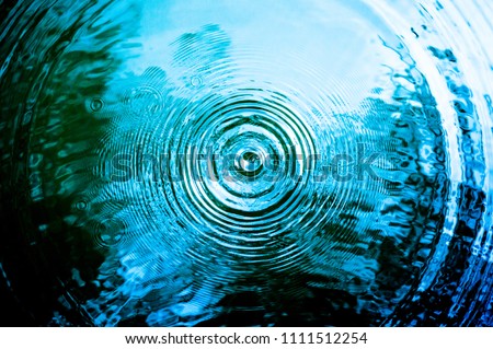 Top view Closeup blue water rings, Circle reflections in pool. Royalty-Free Stock Photo #1111512254