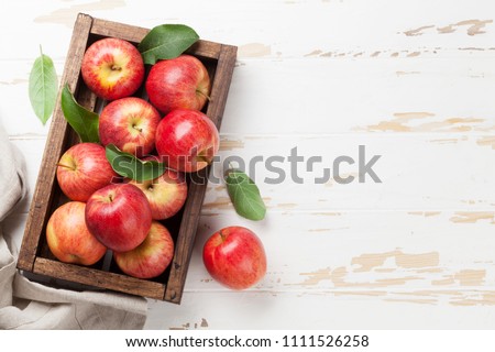 Ripe red apples on wooden table. Top view with space for your text