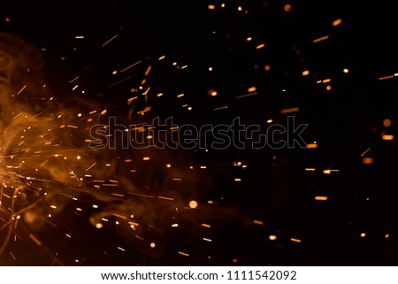 Sparks on black background from welding of steel