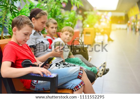 Mom with children on the bench in the mall