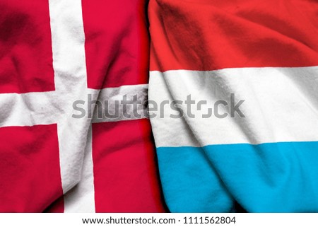 Denmark and Luxembourg flag on cloth texture
