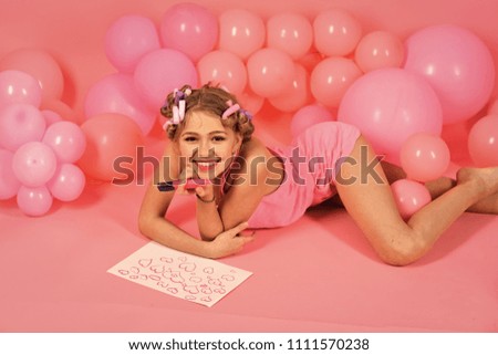 Decoration with inflatable balls. Child draws a heart. Little girl making a card for Valentine's Day. Top view.