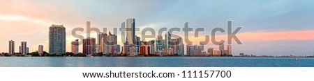 Miami Florida sunset over downtown business and luxury residential buildings, hotels and illuminated bridge over Biscayne Bay. Panoramic colorful Cityscape of World famous travel destination.
