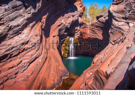 Beautiful Waterfall and private little pool in the Hamersley Gorge, Karijini National Park, Western Australia, May 2018 Royalty-Free Stock Photo #1111593011
