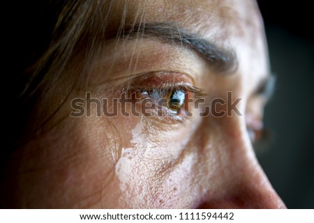 The woman is crying. Close-up eyes and tears. Royalty-Free Stock Photo #1111594442