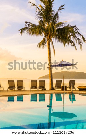 Beautiful outdoor view with umbrella and chair around swimming pool in luxury hotel and resort at sunrise time for travel and vacation