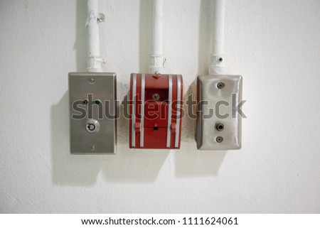 push in pull down switch in case of fire and emergency door release switch against concrete background