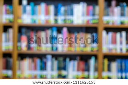 Blurred books on shelf in public library. Blured effect. Background pictures.