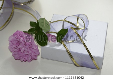 Bouquet of roses and gift box on white background. Congratulation, holiday, lifestyle concept. Space for a text. Top view. Close up. 