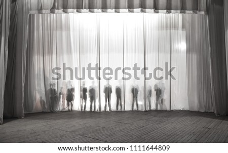 the silhouette of the men behind the curtain in the theater on stage, the shadow behind the scenes is similar to the white and black piano keys.
