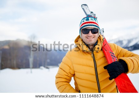 Picture of sporty man with mountain skis