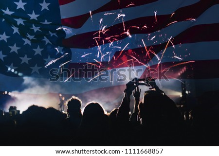 Double exposure with the American flag and cheering crowd and fireworks. Background for independence day - 4th of July.