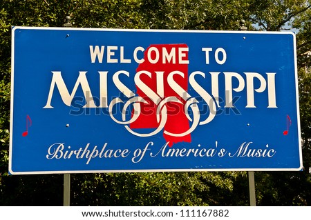 Red, white, and blue sign to welcome travelers to Mississippi - Birthplace of America's Music