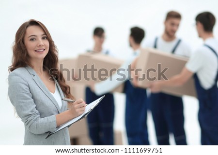 Businessman with documents, creating a stack of cardboard boxes.