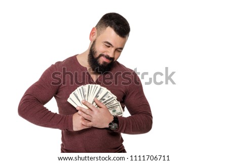 young handsome man with beard holding money dollar bills
