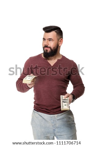 young handsome man with beard holding money dollar bills