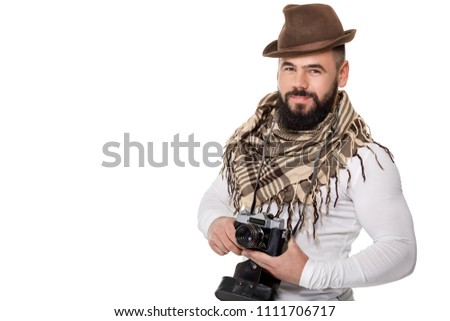 young male photographer with retro camera takes photos on white background