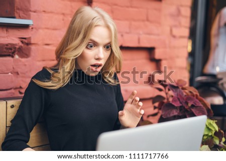 surprised look of blonde, laptop                          