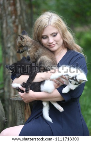 blonde in a forest with a fox