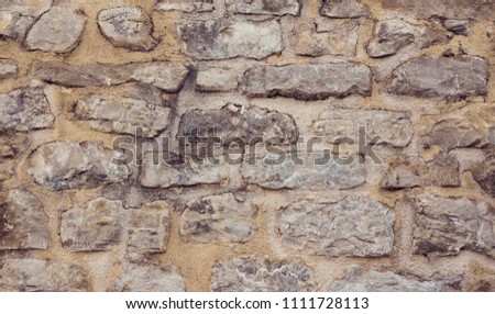 Abstract Grunge Stone wall Background. Old Wall building of natural stone. Rough cement stone Surface Background with copy space. Texture for design. Horizontal Wallpaper