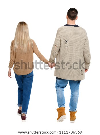  Back view of going couple. walking friendly girl and guy holding hands. Rear view people collection. backside view of person. Isolated over white. Husband and wife walking slowly holding hands.