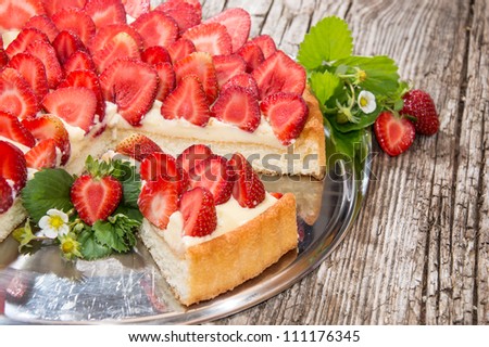 Silver Plate with fresh Strawberry Pie on wooden background