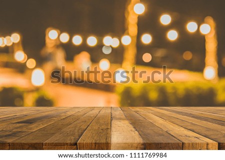 image of blur outdoor restaurant in night time for background usage . (vintage tone).