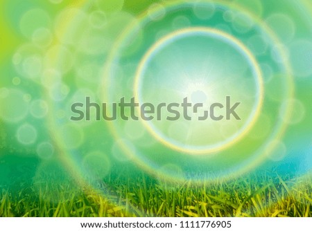 Green grass background with rainbow and bokeh