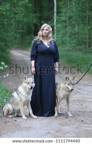 blonde in a forest with a wolf