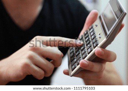 Businessmen are using a calculator.