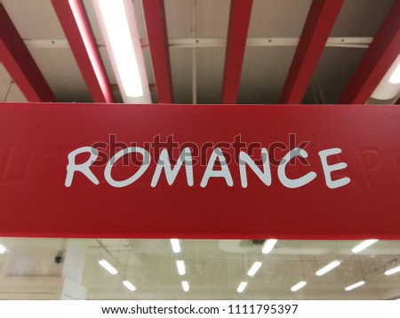Signage for the romance section of a bookstore.