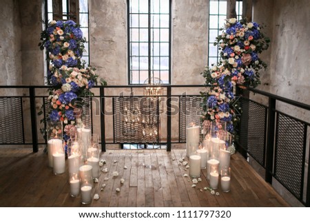 decor by flowers and candles at the loft apartment Royalty-Free Stock Photo #1111797320