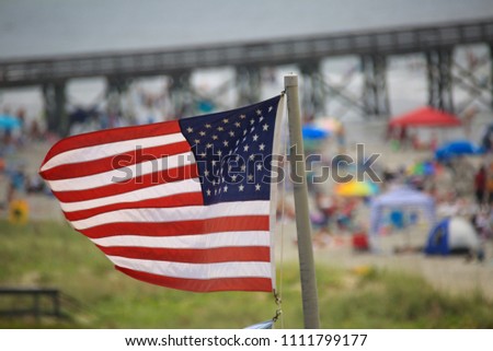 Proud American Flag Flying at the Beach