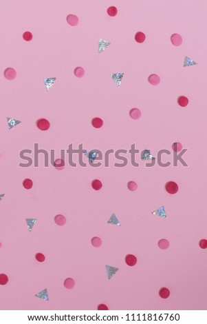 red and pink dots and cut paper on a pink paper as background, minimal, flat lay style. 