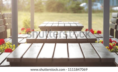 Wooden tables are at the summer outdoor-cafe, gentle evening sunlights.