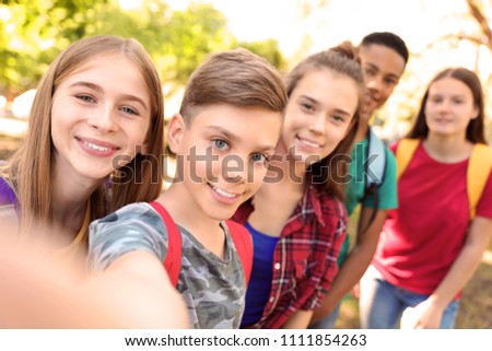 Group of children taking selfie outdoors. Summer camp