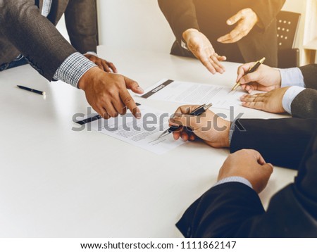 Group of business man signing a contract, meeting together.