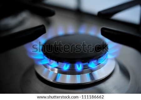 gas burning from a kitchen gas stove Royalty-Free Stock Photo #111186662