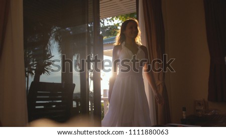 Pretty smiles girl coming home during sunset with lens flare effects
